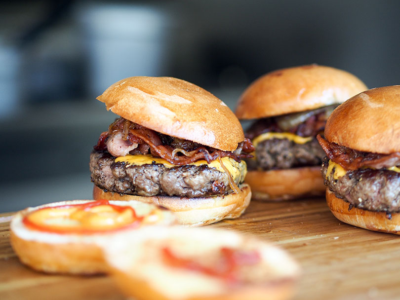 Three hamburgers on a table