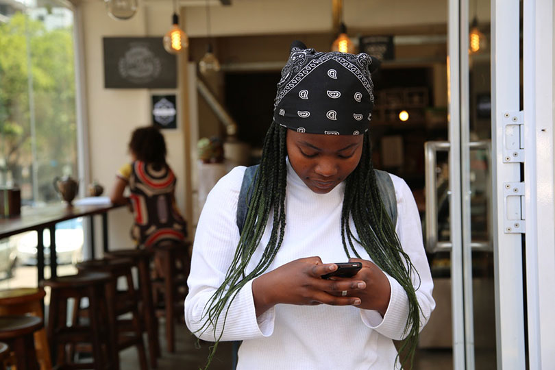 Young woman using her mobile phone.