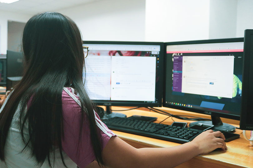 Woman sitting at a desk using a PC