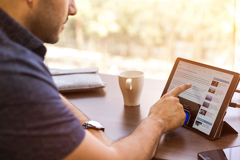 Man sitting at desk interacting with LinkedIn post.