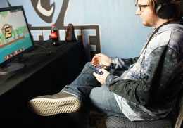 Young man playing video game at a desk