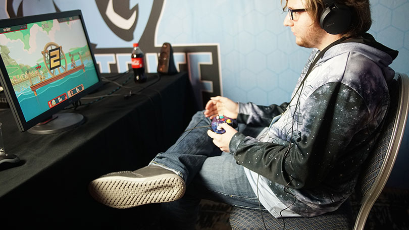 Young man playing video game at a desk