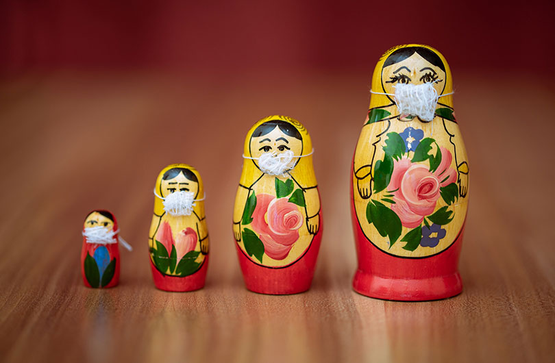 Image of Russian nesting dolls wearing personal protection masks.