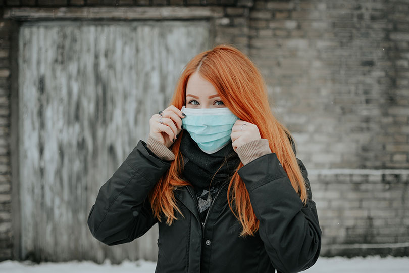 Woman wearing surgical mask. 