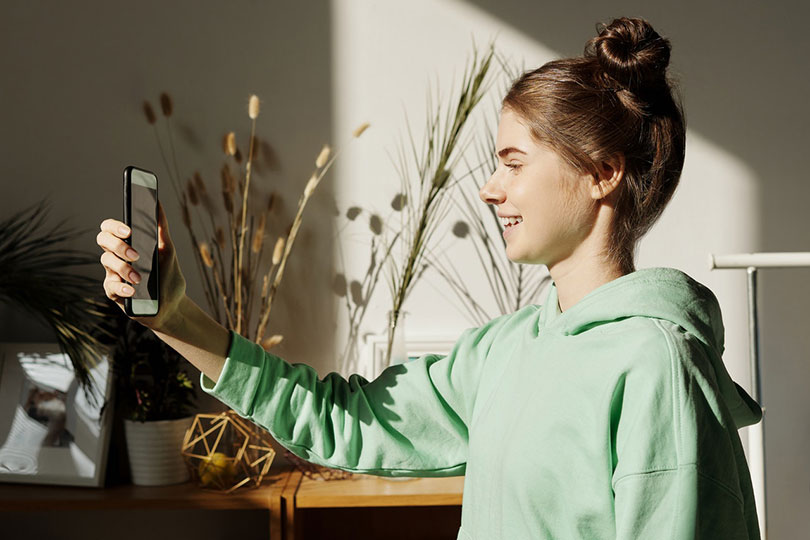 Teenage girl holding a smart phone.