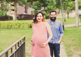 Smiling pregnant woman with man in foreground